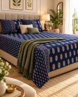 Mehfil Blue Everyday Cotton bedsheet with light floral buta on navy, styled with an olive throw
