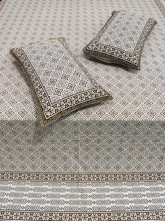 Decorative pillows with intricate patterns on a matching fabric background