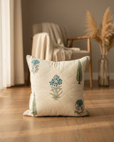 Gulmohar grey quilted cushion cover styled with blue floral and tree motifs