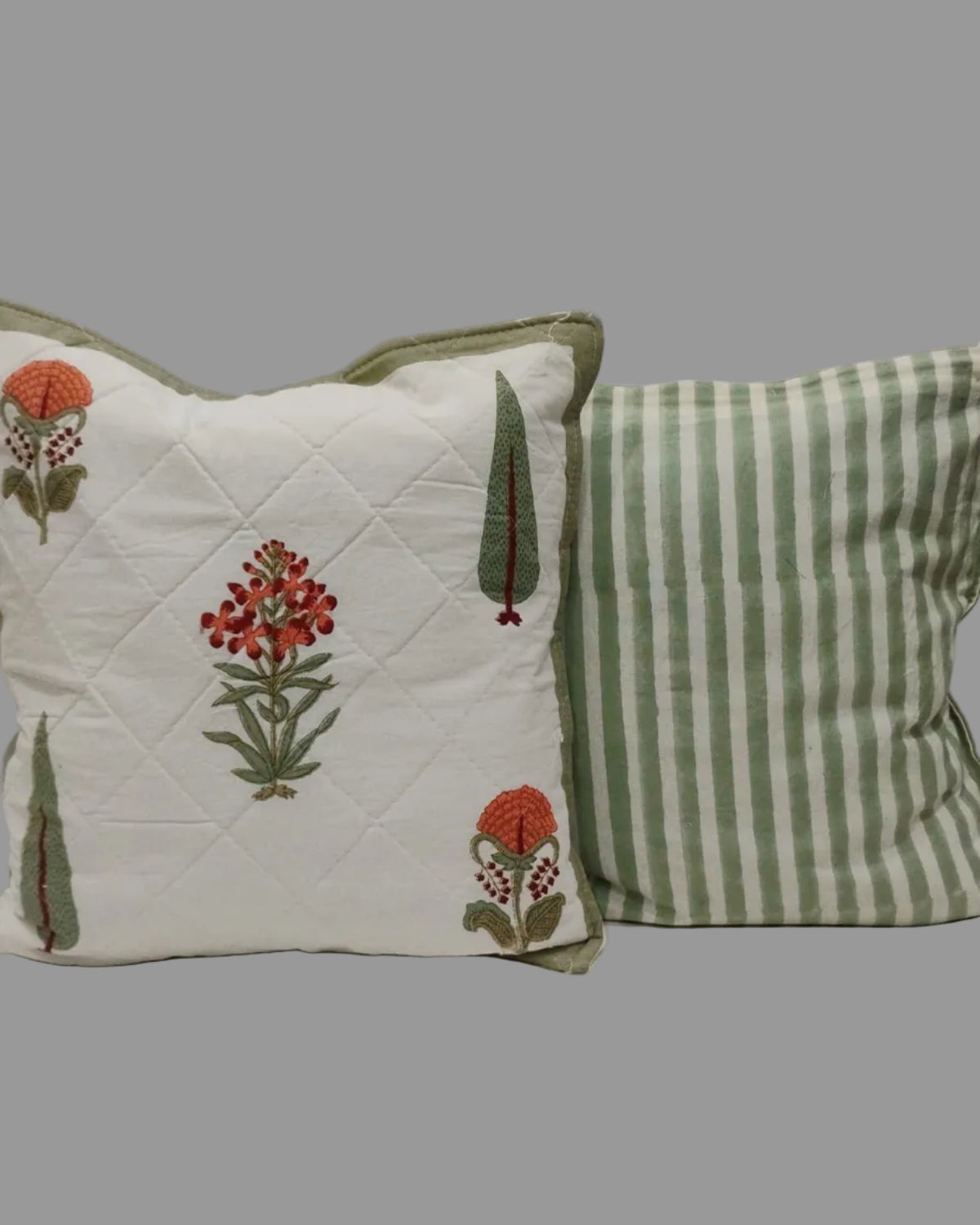 Gulmohar olive quilted cushion cover shown beside its green striped reverse