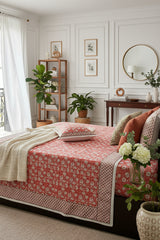 Kumud orange floral pure cotton bedsheet – styled on a bed
