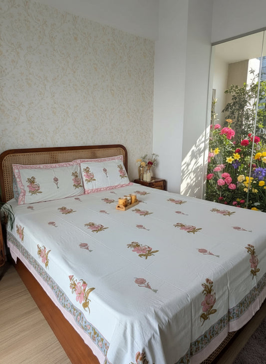 Bedroom with a bed featuring floral bedding and a wooden headboard.