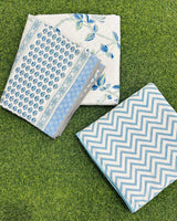 Reversible blue floral mulmul dohar folded to show the printed side and the chevron reverse