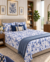 Pallav Blue Everyday Cotton bedsheet with indigo florals on white, styled with navy cushions and a blue throw