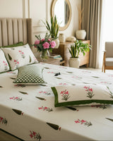 Pushpita Green Everyday Cotton bedsheet – pink orchid florals and green motifs on a beige bed