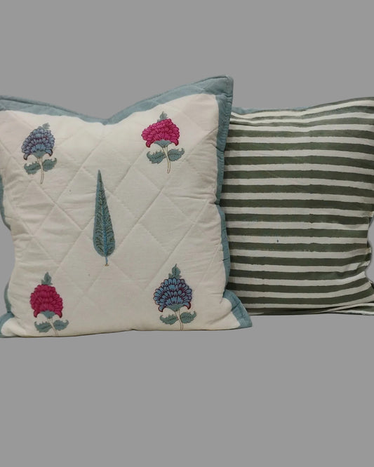 Tarangini blue quilted cushion cover shown beside its green striped reverse