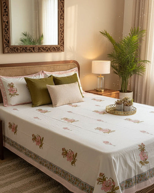 Kusum pink rose hand block printed pure cotton bedsheet styled on a bed