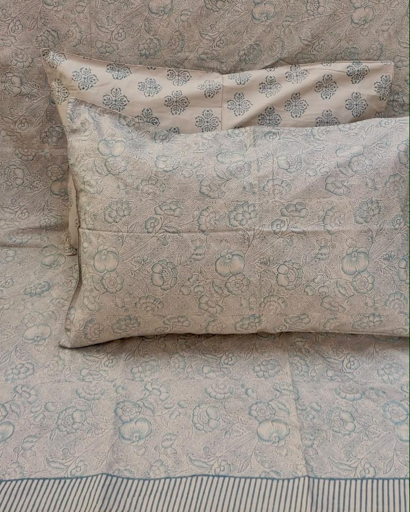 Alpana hand block Percale Cotton bedsheet with a grey-blue floral and paisley print, shown with matching pillow covers