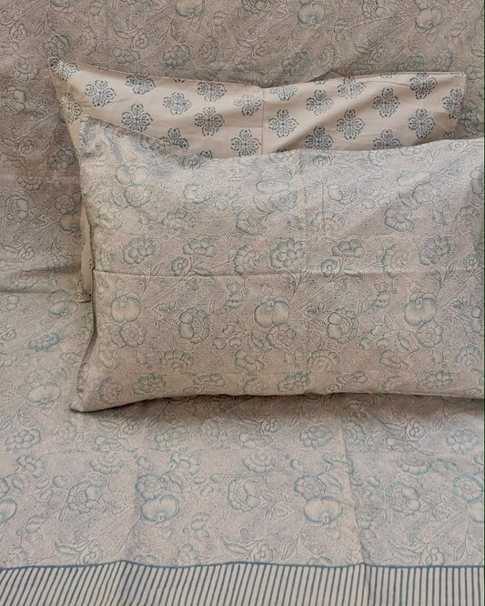 Alpana hand block Percale Cotton bedsheet with a grey-blue floral and paisley print, shown with matching pillow covers
