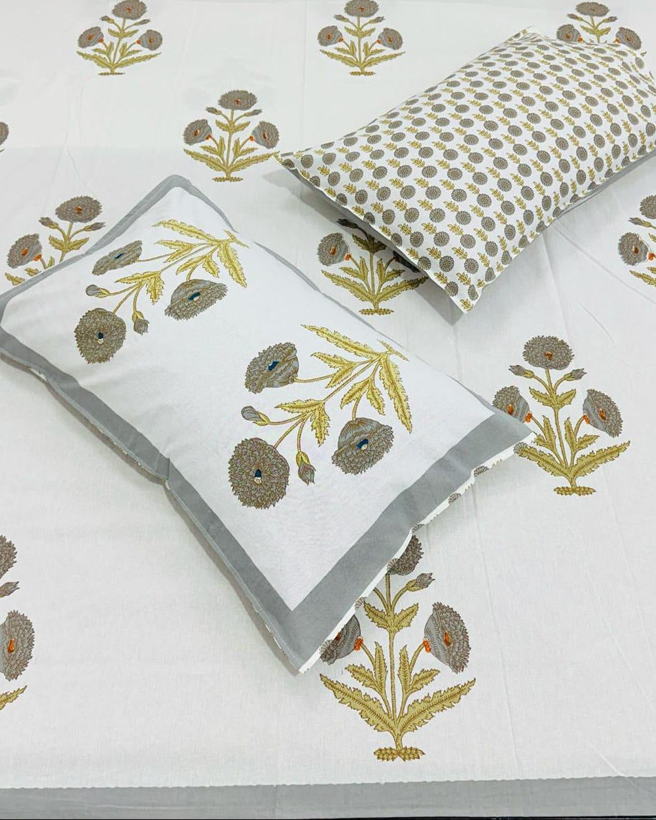 Floral patterned bed sheets with matching pillows on a white background