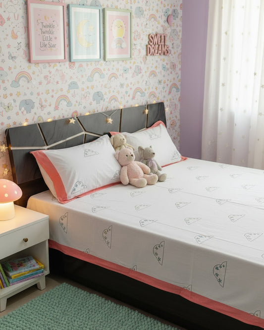 Hand block cloud and star print kids cotton bedsheet on white with a peach pink border