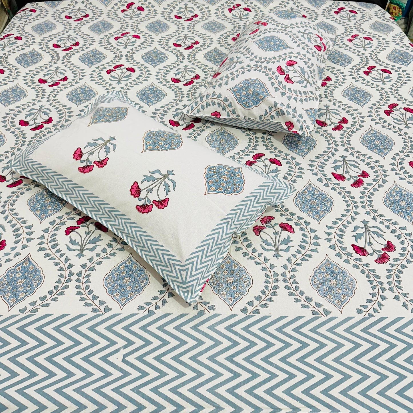 Floral and geometric patterned bedsheet with pillows in Blue, pink and white