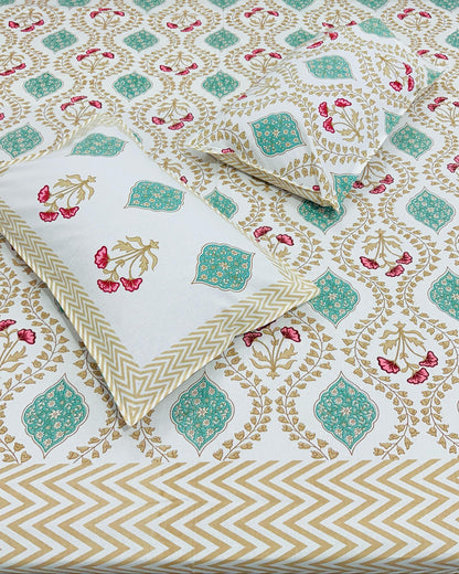 Close-up of beige gold floral vine cotton fabric with a teal medallion and gold chevron border