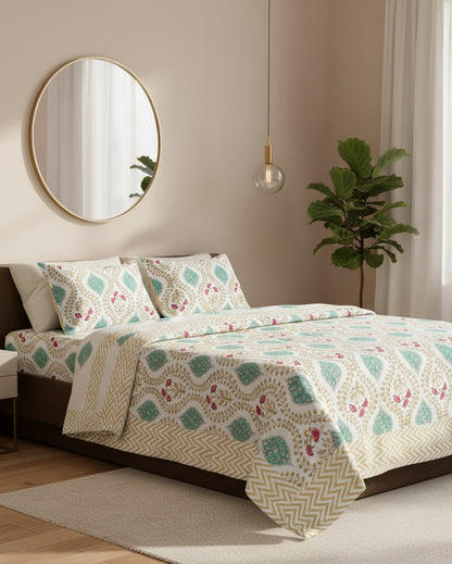 Floral patterned bedsheet with a chevron border on a bed in yellow, green and magenta