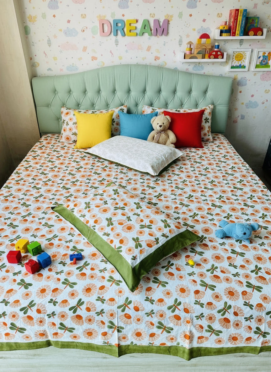 Bed with floral patterned bedspread and green border in a room.