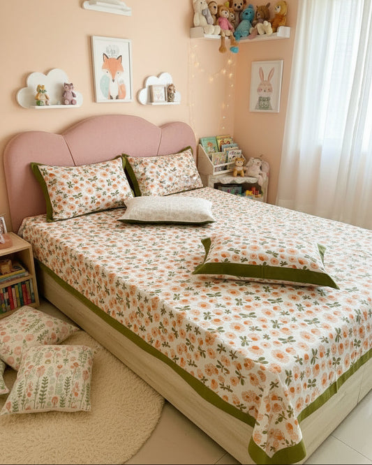 Bed with floral bedspread and green border in a kids room