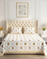 Chameli Yellow bedsheet, grey trellis jaal on white with mustard roundel bloom booti, on a bed with a tufted wingback headboard