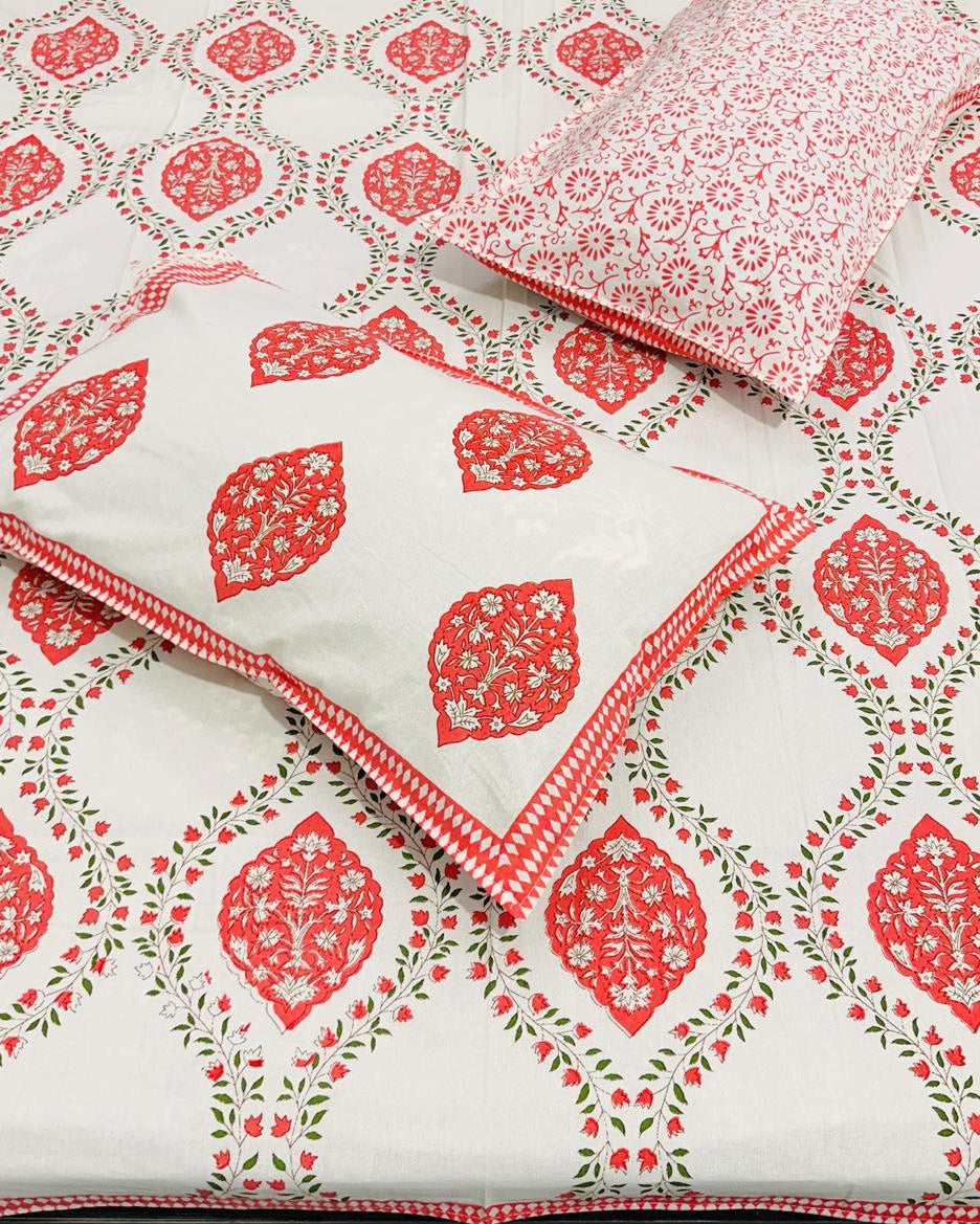 Red and green patterned bedsheet on a white background