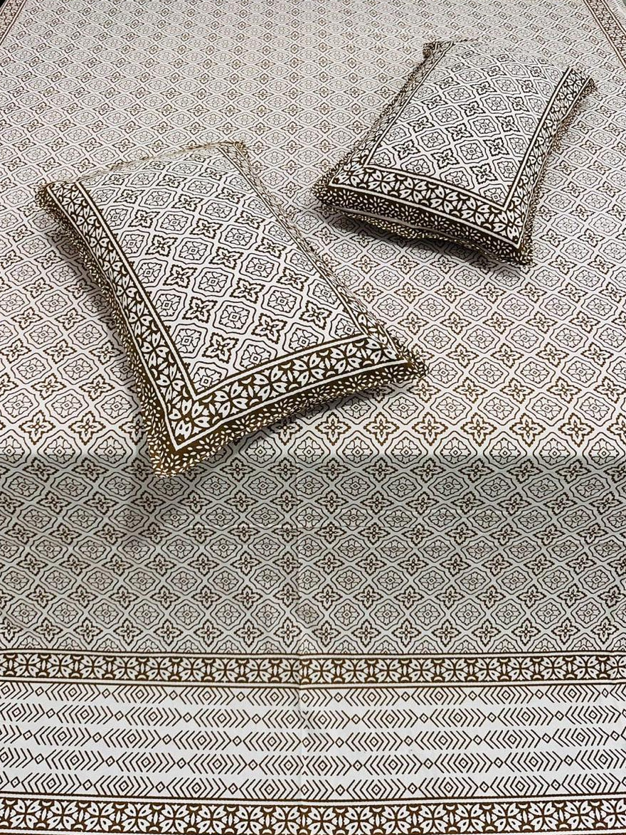 Decorative pillows with intricate patterns on a matching fabric background