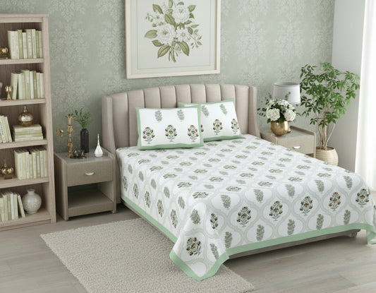 Bed with floral patterned bedding and matching pillows in a bedroom setting.