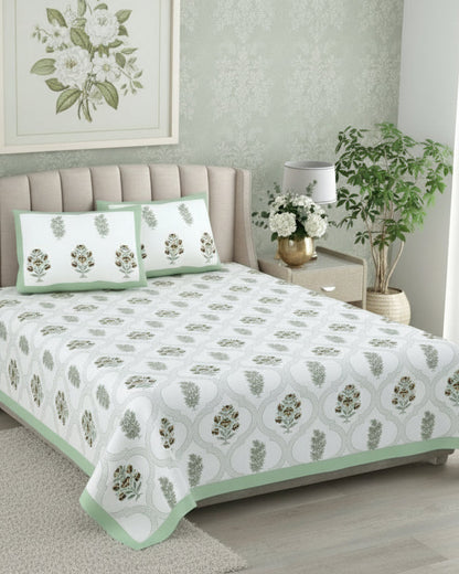 Sage green medallion trellis cotton bedsheet with mustard florals styled on a beige tufted bed