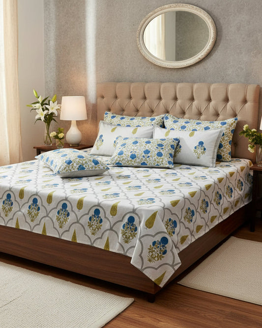Floral patterned bedding set with white pillow on a matching fabric background