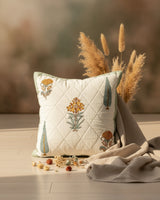 Gulmohar green quilted cushion cover styled with floral and cypress tree motifs