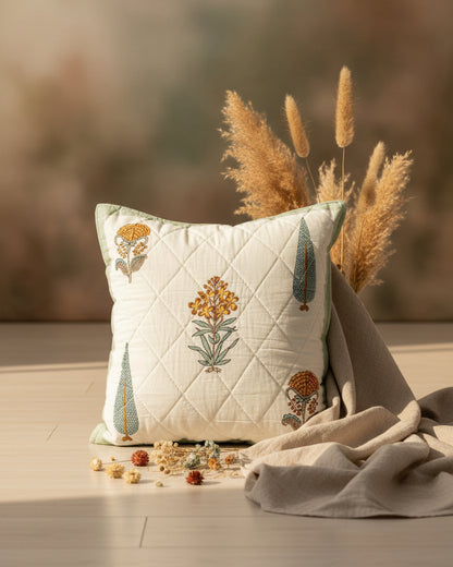 Gulmohar green quilted cushion cover styled with floral and cypress tree motifs