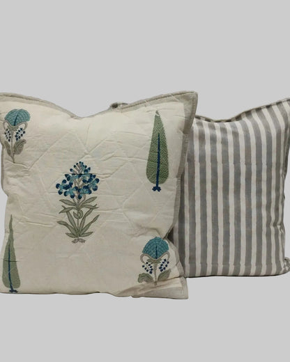 Gulmohar grey quilted cushion cover shown beside its grey striped reverse
