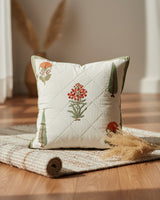 Gulmohar olive quilted cushion cover styled with orange floral and green tree motifs