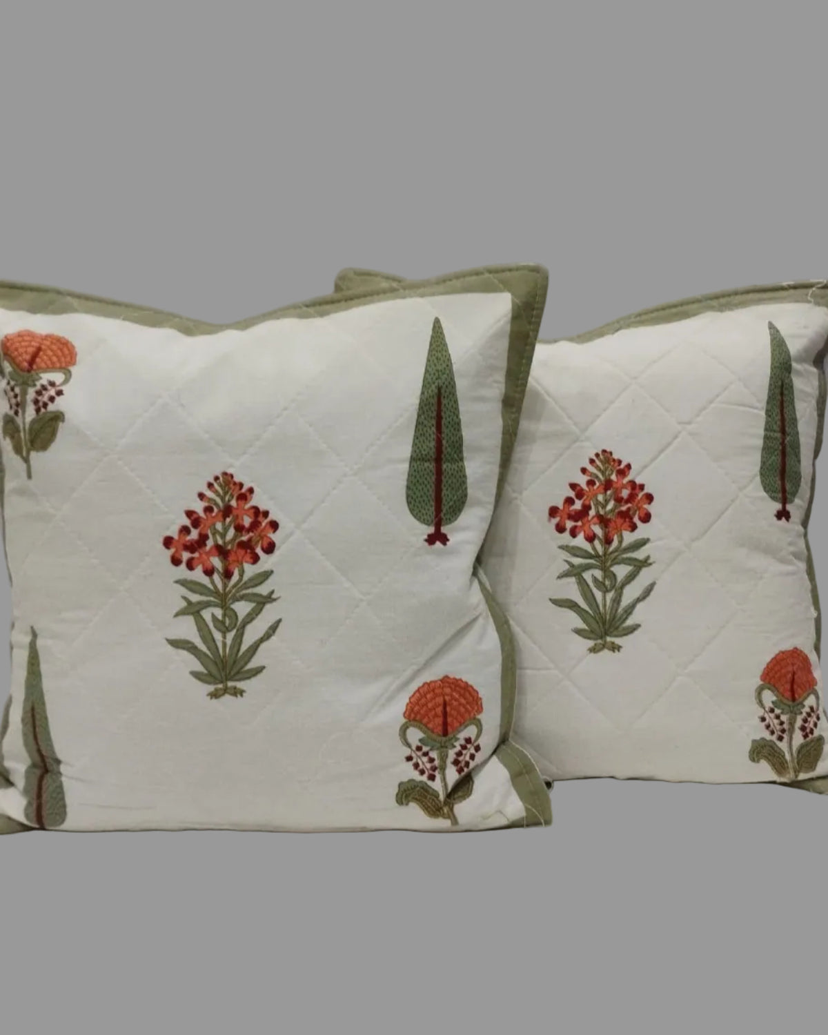 Pair of Gulmohar olive quilted cushion covers with orange floral and green tree motifs