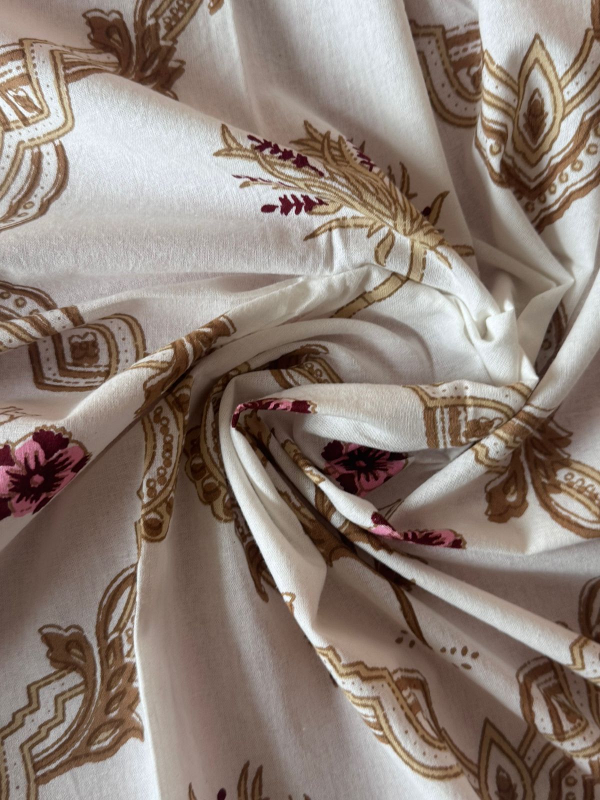 Close-up of patterned fabric with floral and geometric designs.