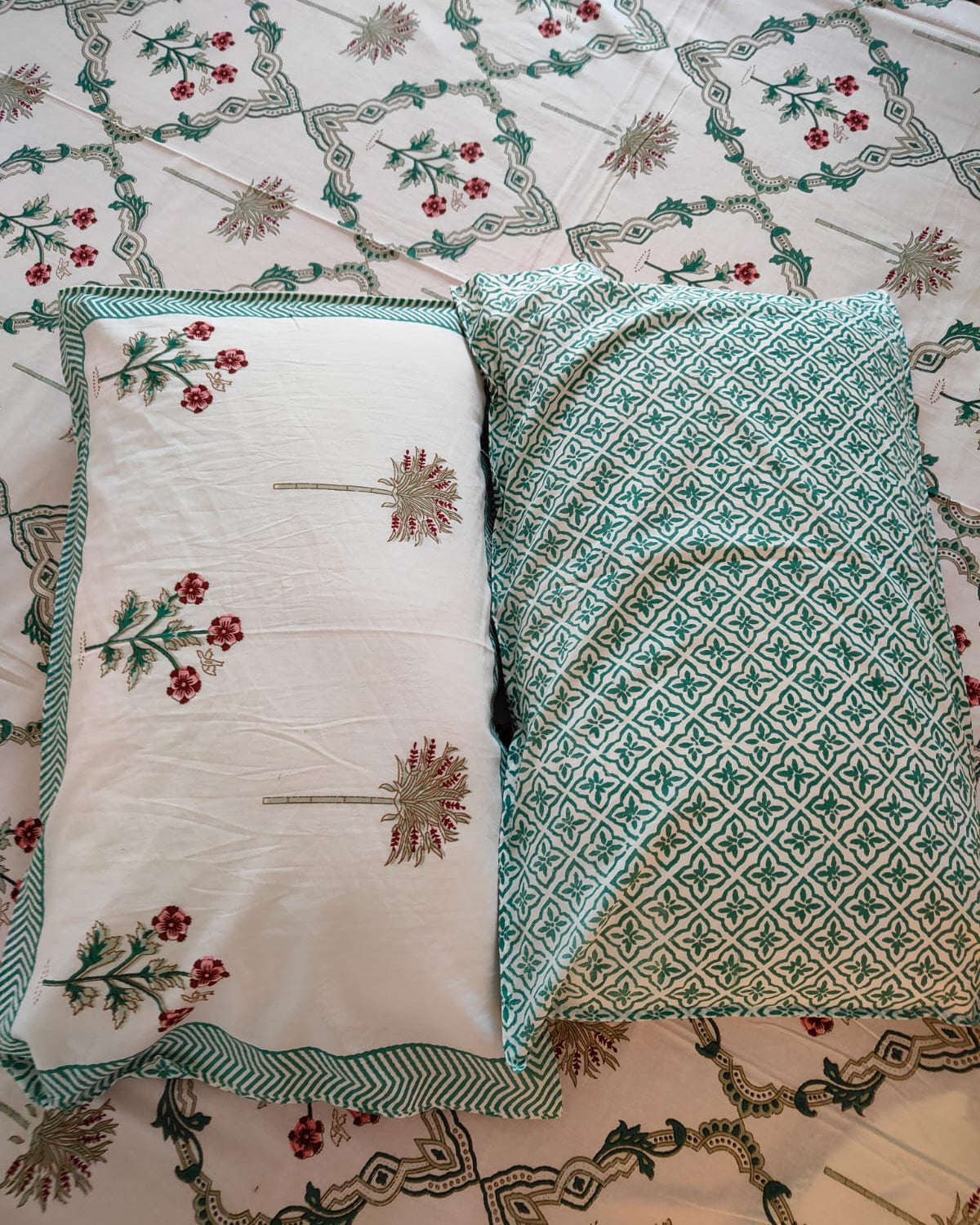 Two reversible pillows on a patterned fabric