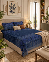 Tarang Blue Everyday Cotton bedsheet with small motifs on navy and an arched border, styled with a cream throw