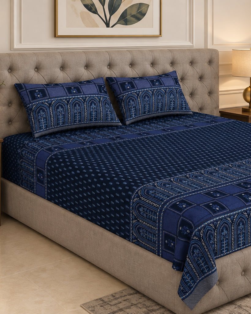 Tarang Blue bedsheet and pillow covers on a grey tufted bed