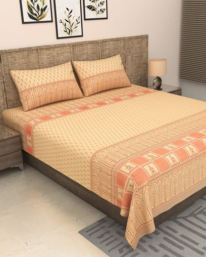 Tarang Peach bedsheet on a bed with a woven headboard
