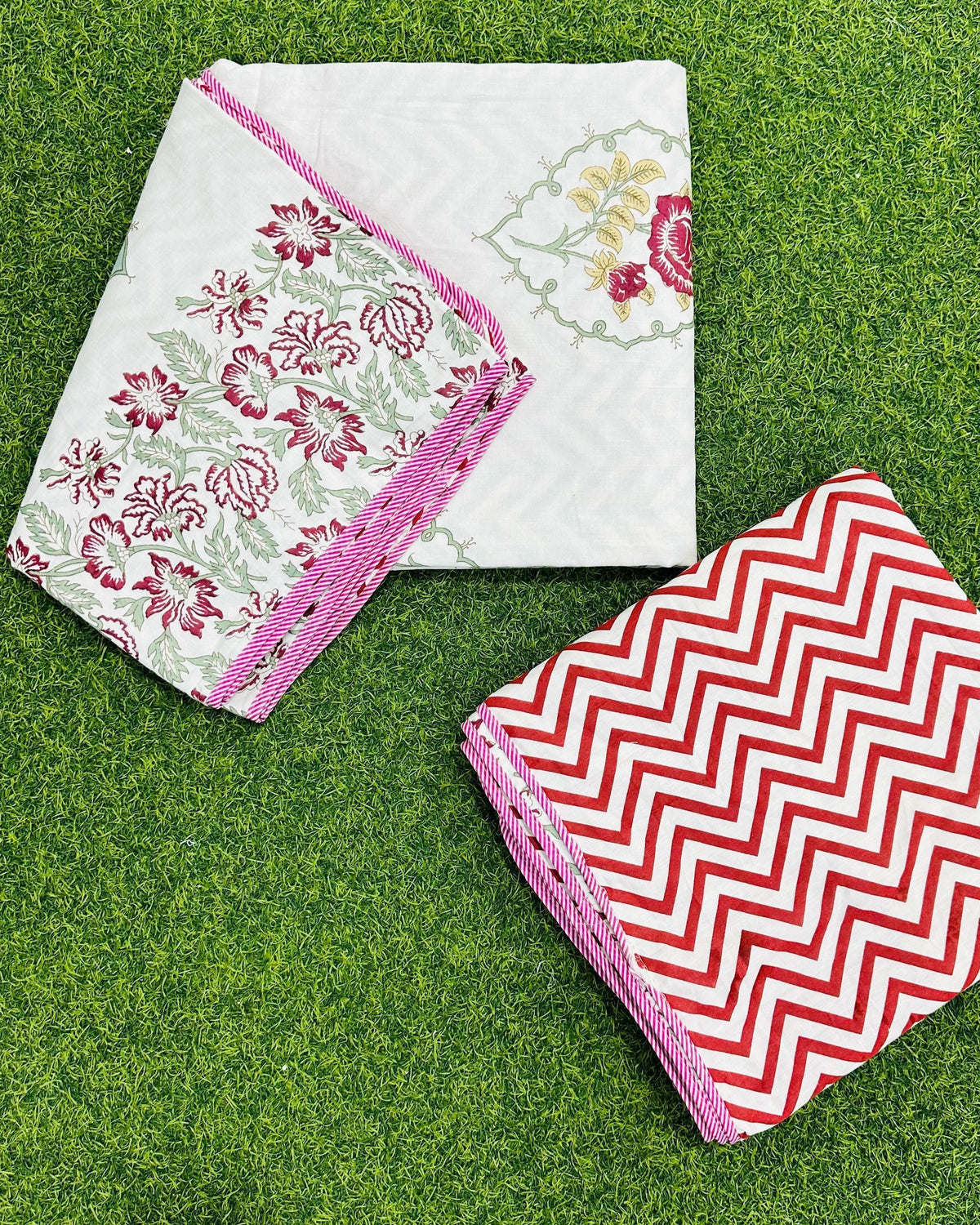 Deep red and maroon rose floral reversible mulmul cotton dohar with a pink piped edge and red chevron reverse
