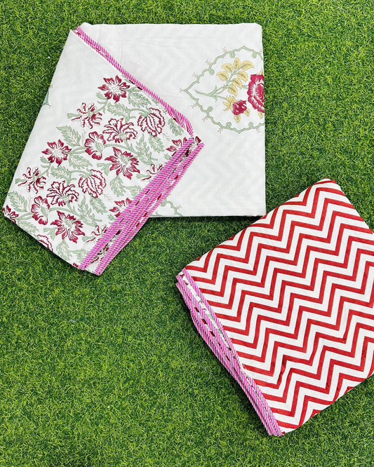 Deep red and maroon rose floral reversible mulmul cotton dohar with a pink piped edge and red chevron reverse