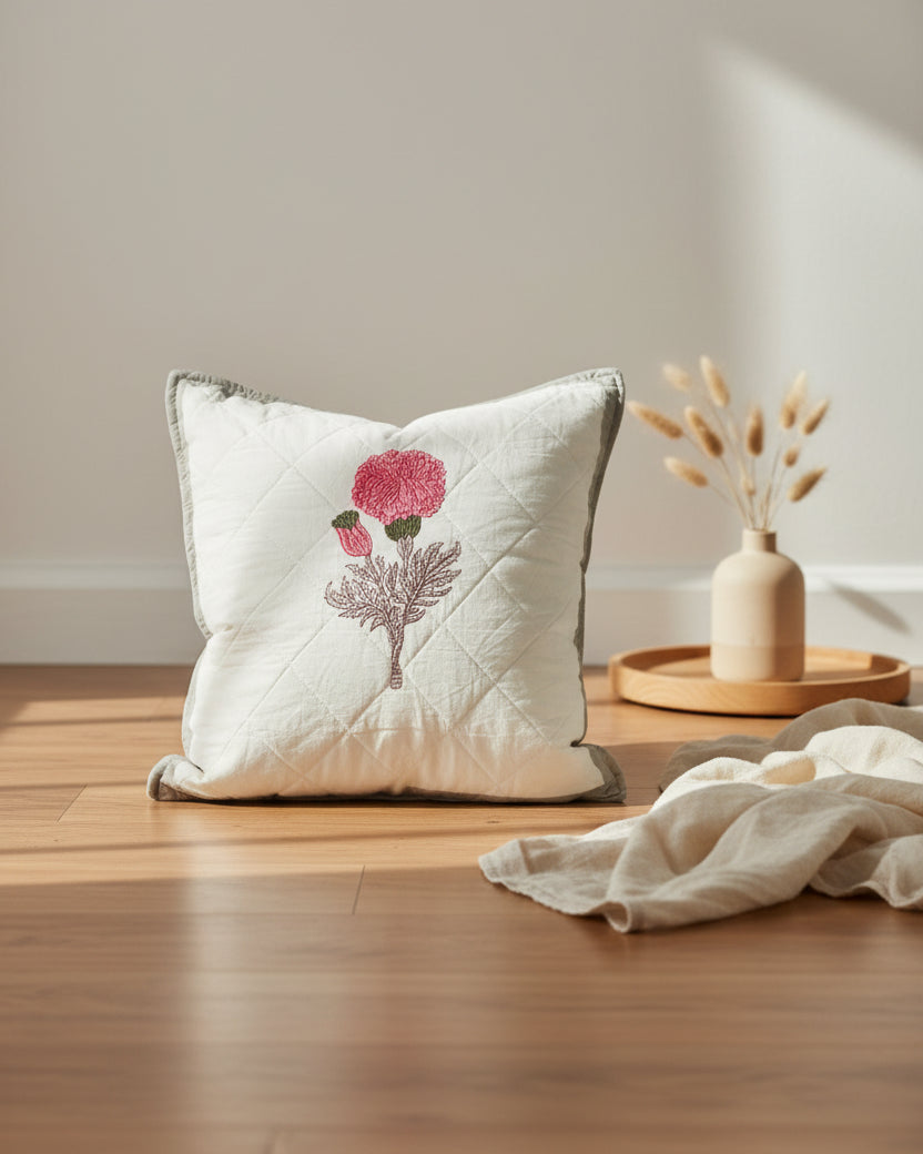 Kesariya grey quilted cushion cover styled with a pink flower motif