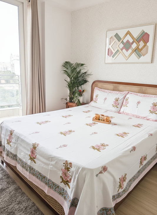 Bedroom with floral-patterned cotton bedsheet and reversible pillows