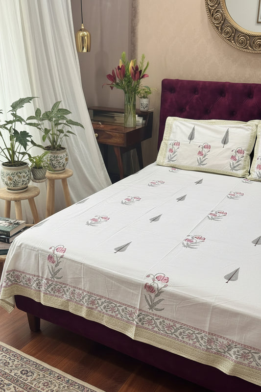 Bed with floral-patterned bedding in a bedroom setting