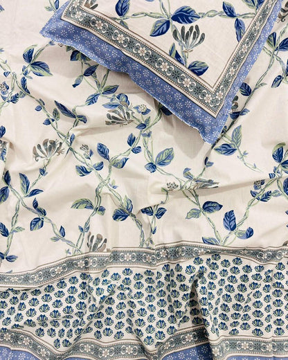 Single size blue floral cotton bedsheet with trailing vines on ivory and a printed blue border