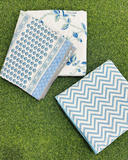Reversible blue floral mulmul dohar folded to show the printed side and the chevron reverse