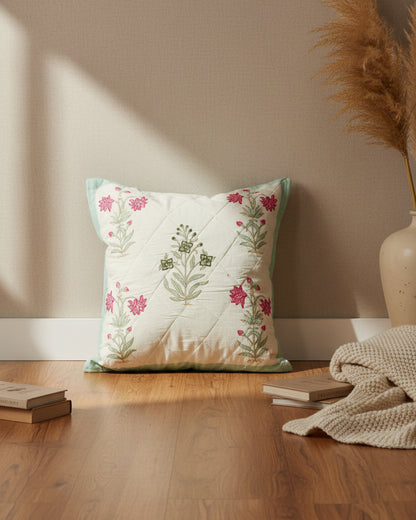 Malika blue quilted cushion cover styled with pink, mint, and green floral motifs