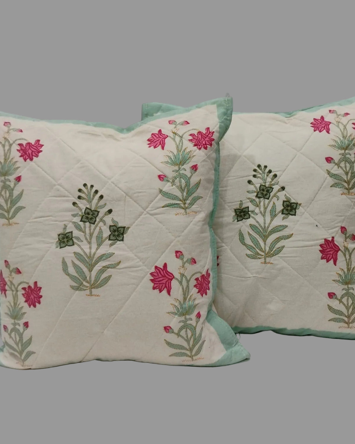 Pair of Malika blue quilted cushion covers with pink, mint, and green flowers