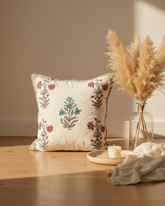 Malika grey quilted cushion cover styled with pink and blue floral motifs