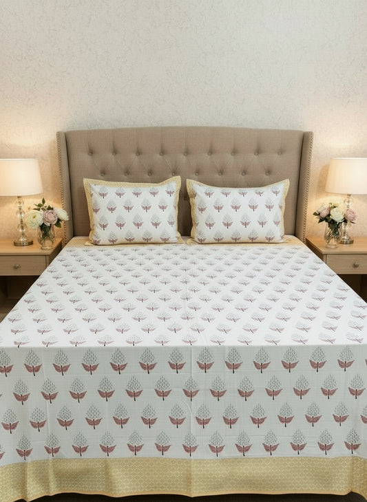 Bed with floral patterned bedding and pillows in a bedroom setting.