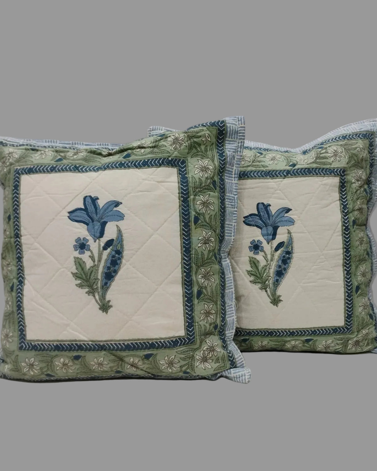Pair of Mridula blue quilted cushion covers with blue flower panels and green borders