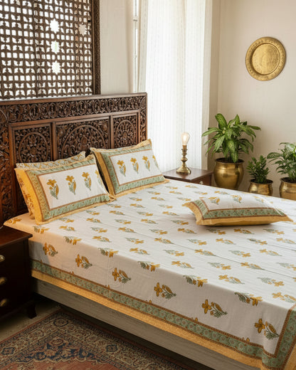 Mridula yellow floral pure cotton bedsheet – styled on a bed