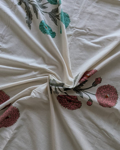 Nargis Green Everyday Cotton bedsheet – close-up of ivory cotton with coral and teal motifs